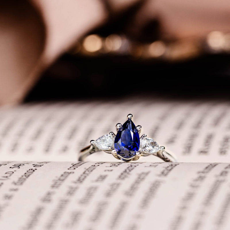 blue-sapphire-pear-cut-three-stone-engagement-ring-with-diamond-accents_10