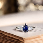 blue-sapphire-pear-cut-three-stone-engagement-ring-with-diamond-accents_10