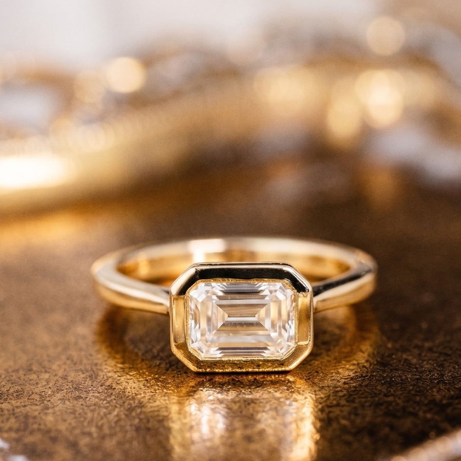 The Adeline | Hidden Halo Emerald Cut Moissanite Engagement Ring with Bezel Setting