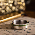 in-stock-the-fairbanks-mens-titanium-wedding-band-with-green-imperial-diopside-gold-flakes-offset-inlay-size-10-5-7mm-wide