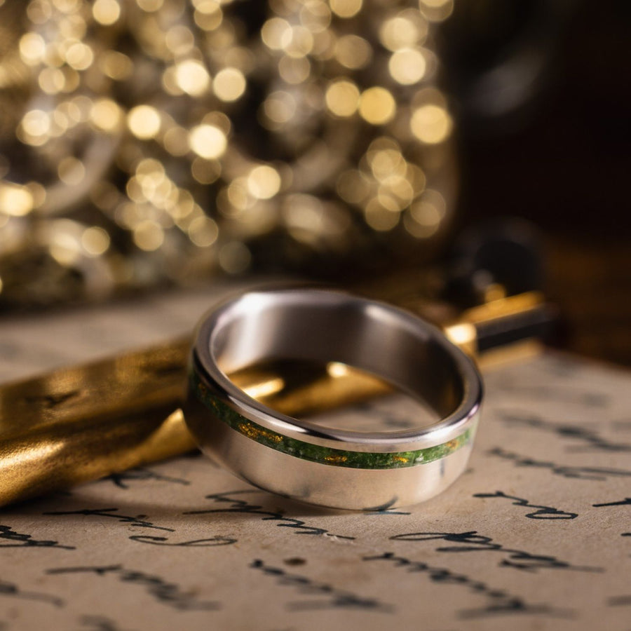 in-stock-the-fairbanks-mens-titanium-wedding-band-with-green-imperial-diopside-gold-flakes-offset-inlay-size-10-5-7mm-wide