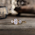 oval-diamond-three-stone-engagement-ring-round-diamond-accents-trilogy-the-wren-rustic-and-main