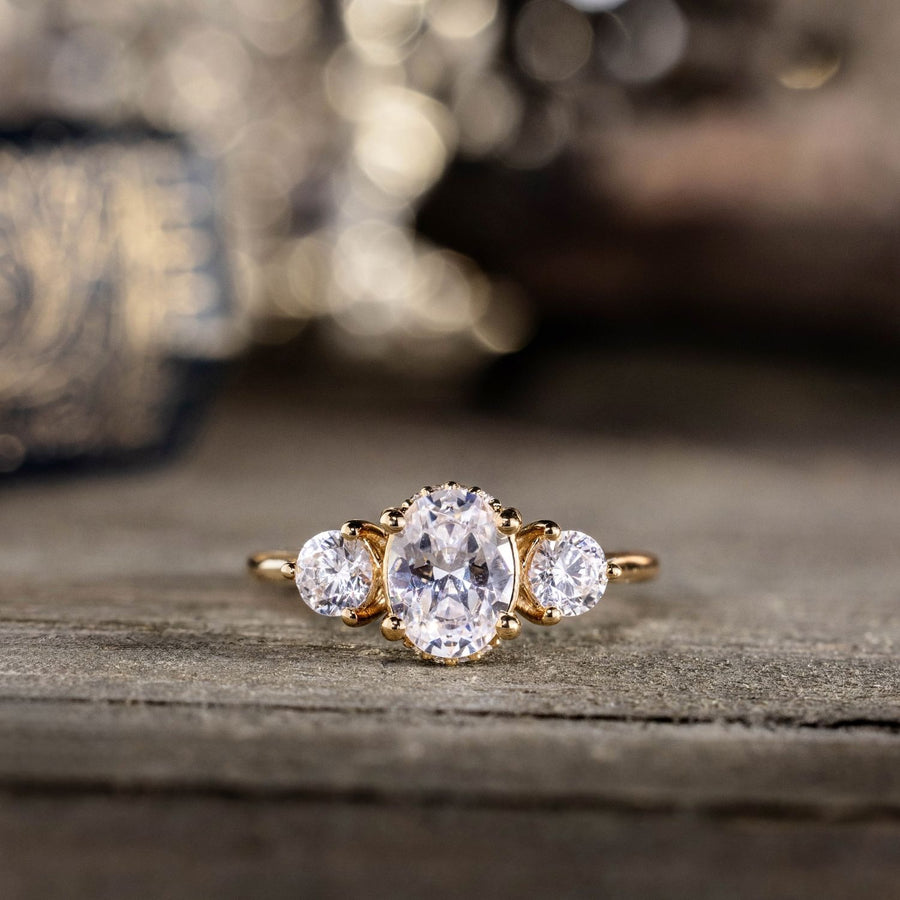 oval-diamond-three-stone-engagement-ring-round-diamond-accents-trilogy-the-wren-rustic-and-main