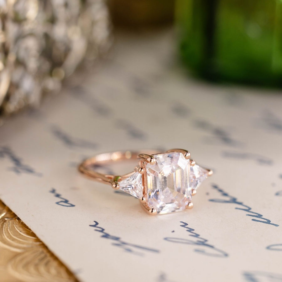 Emerald-cut-diamond-three-stone-engagement-ring-trillion-diamond-accent-stones-the-ingrid-rustic-and-main