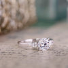 round-diamond-three-stone-engagement-ring-pear-shaped-diamond-accents-the-odette-rustic-and-main