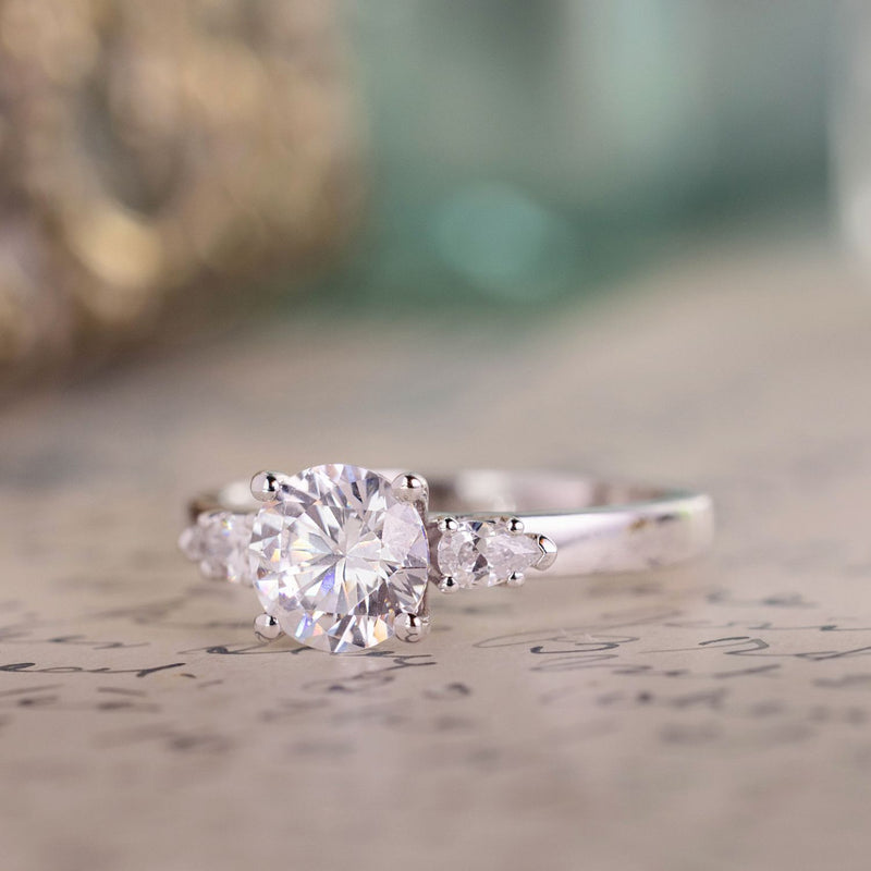 round-diamond-three-stone-engagement-ring-pear-shaped-diamond-accents-the-odette-rustic-and-main