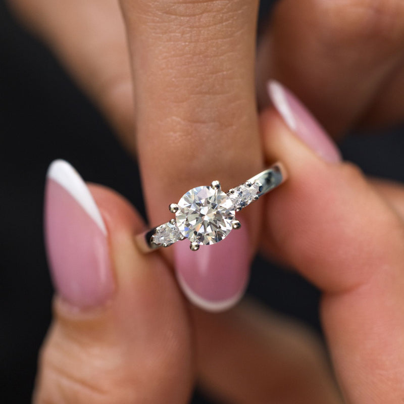round-diamond-three-stone-engagement-ring-pear-shaped-diamond-accents-the-odette-rustic-and-main