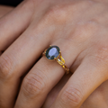 beatrix-yellow-gold-oval-moss-agate-ring-on-hand-close-up