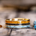 the-cascade-mens-gold-wedding-band-with-meteorite-dust-turquoise-fossilized-amber