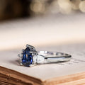 the-diana-blue-sapphire-pear-cut-three-stone-engagement-ring-diamond-accents