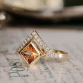 the-eileen-art-deco-inspired-princess-cut-padparadscha-sapphire-engagement-ring-diamond-accents