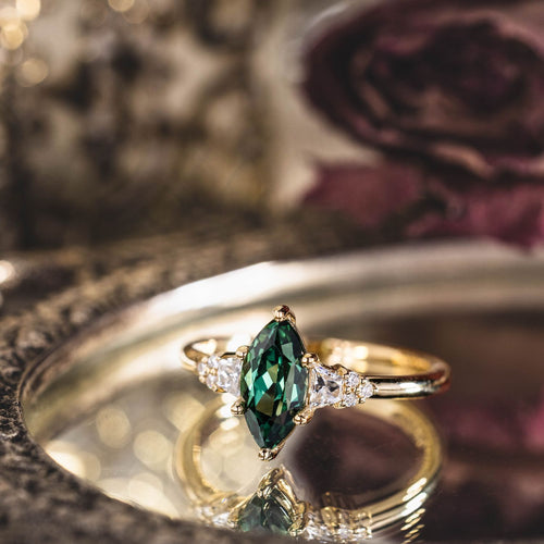 the-guinevere-green-sapphire-marquise-cut-engagement-ring-with-diamond-accents