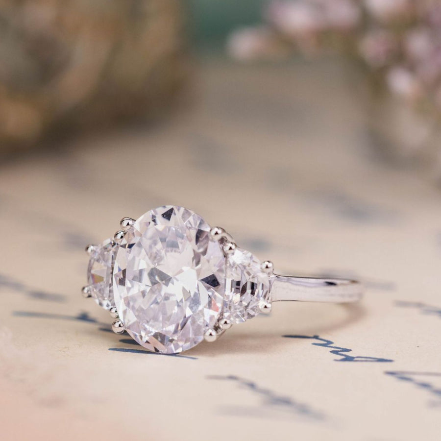 the-harriet-oval-diamond-three-stone-engagement-ring-half-moon-side-stones