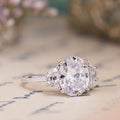 the-harriet-oval-diamond-three-stone-engagement-ring-half-moon-side-stones