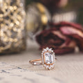 the-hazel-emerald-cut-bezel-engagement-ring-with-diamond-halo