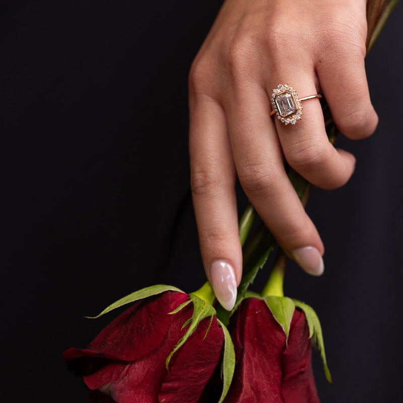 the-hazel-emerald-cut-bezel-engagement-ring-with-diamond-halo
