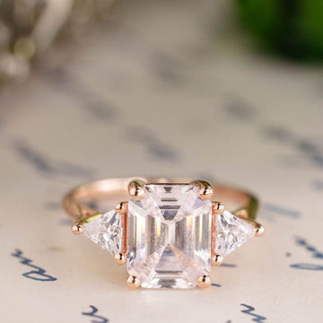 the-ingrid-three-stone-emerald-cut-diamond-engagement-ring-trillion-diamond-side-stones