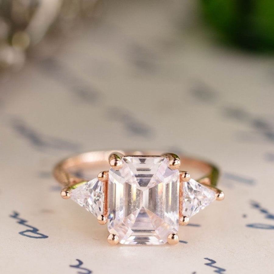 the-ingrid-three-stone-emerald-cut-diamond-engagement-ring-trillion-diamond-side-stones