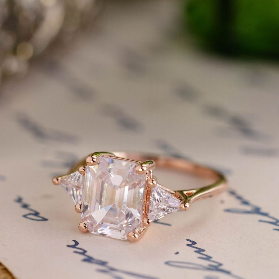the-ingrid-three-stone-emerald-cut-diamond-engagement-ring-trillion-diamond-side-stones