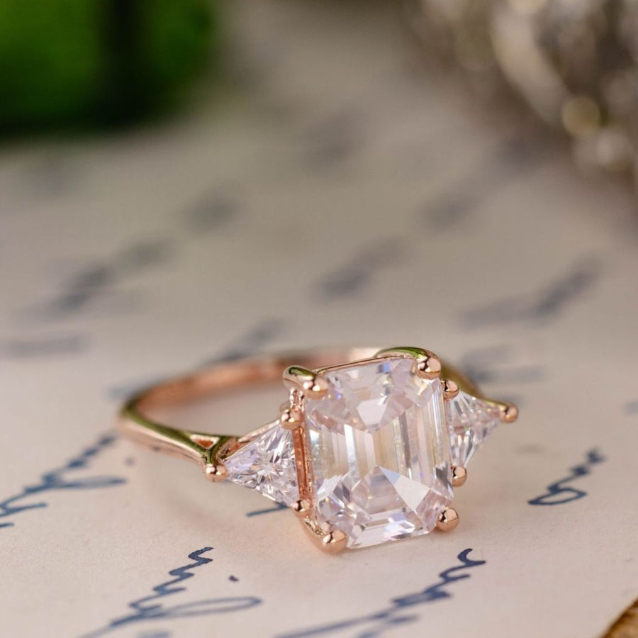 the-ingrid-three-stone-emerald-cut-diamond-engagement-ring-trillion-diamond-side-stones