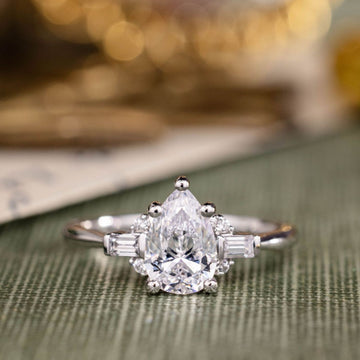 the-juno-pear-shaped-diamond-engagement-ring-straight-baguette-round-diamond-accents