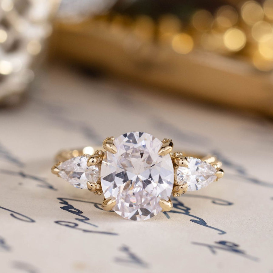 the-marielle-three-stone-oval-diamond-engagement-ring-pear-shaped-diamond-accents-pave-setting