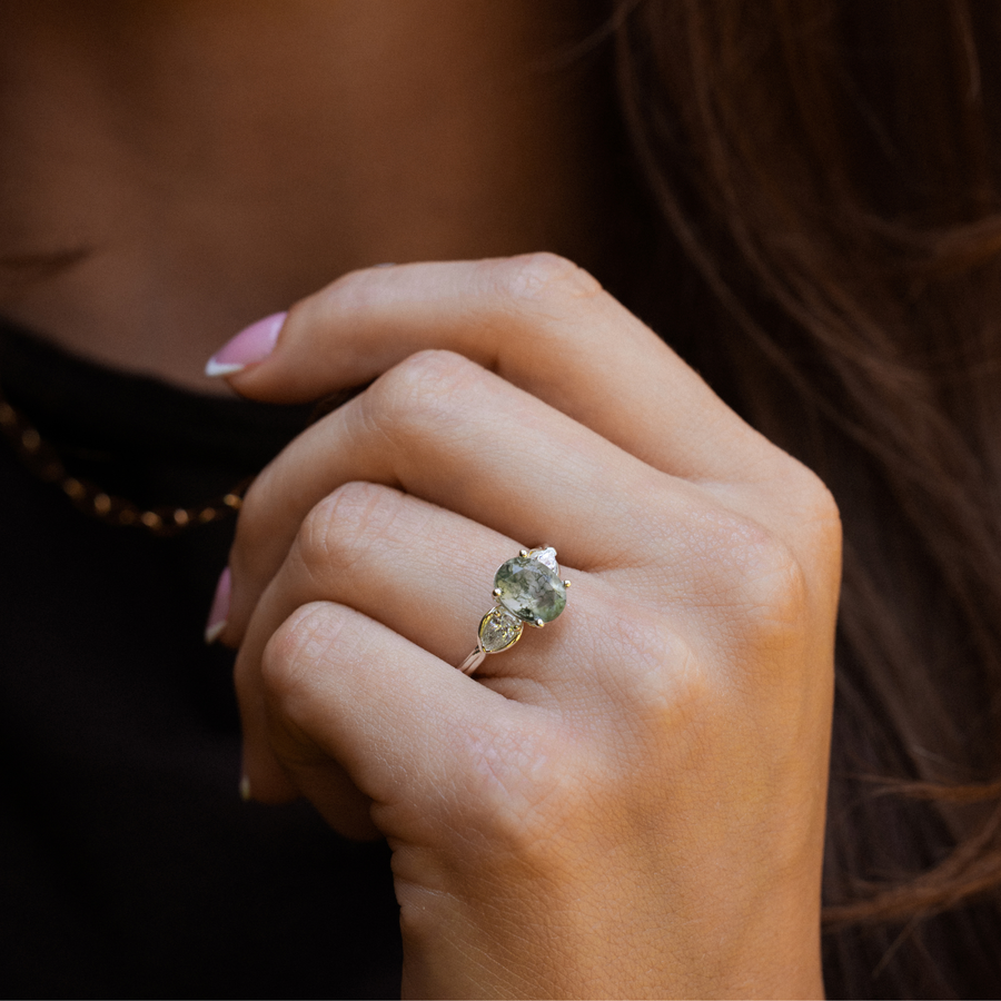 primrose-white-gold-oval-moss-agate-ring-on-hand-close-up