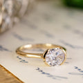 the-soren-east-west-oval-diamond-solitaire-engagement-ring-modern-half-bezel-setting