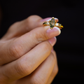titania-yellow-gold-marquise-moss-agate-ring-handheld-close-up