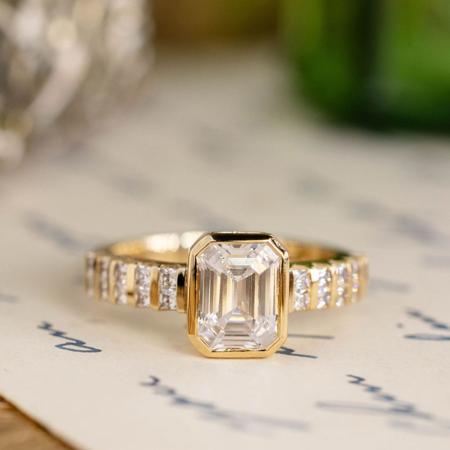the-vivienne-emerald-cut-diamond-engagement-ring-bezel-setting-diamond-accented-band