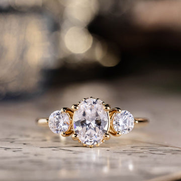 the-wren-oval-diamond-three-stone-engagement-ring-round-diamond-accents