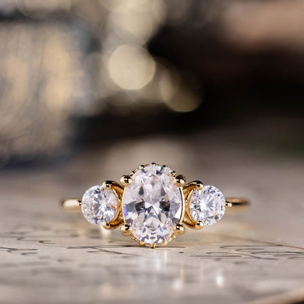 the-wren-oval-diamond-three-stone-engagement-ring-round-diamond-accents