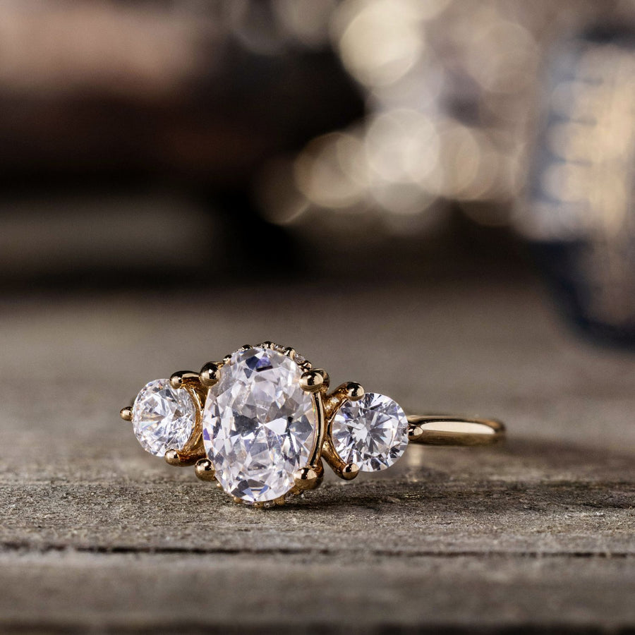 the-wren-oval-diamond-three-stone-engagement-ring-round-diamond-accents