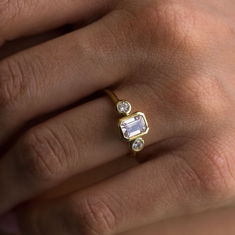three-stone-emerald-cut-diamond-engagement-ring-round-diamond-accents-bezel-setting-the-marcelline-rustic-and-main