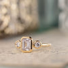 three-stone-emerald-cut-diamond-engagement-ring-round-diamond-accents-bezel-setting-the-marcelline-rustic-and-main
