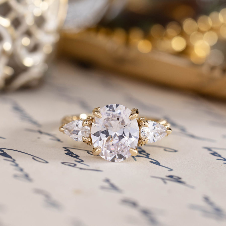 three-stone-oval-diamond-engagement-ring-pear-shaped-diamond-accents-pave-setting-the-marielle-rustic-and-main