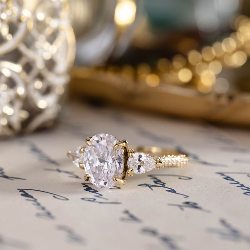 three-stone-oval-diamond-engagement-ring-pear-shaped-diamond-accents-pave-setting-the-marielle-rustic-and-main