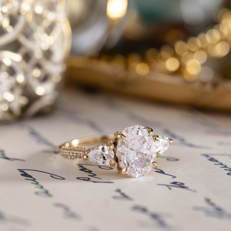 three-stone-oval-diamond-engagement-ring-pear-shaped-diamond-accents-pave-setting-the-marielle-rustic-and-main