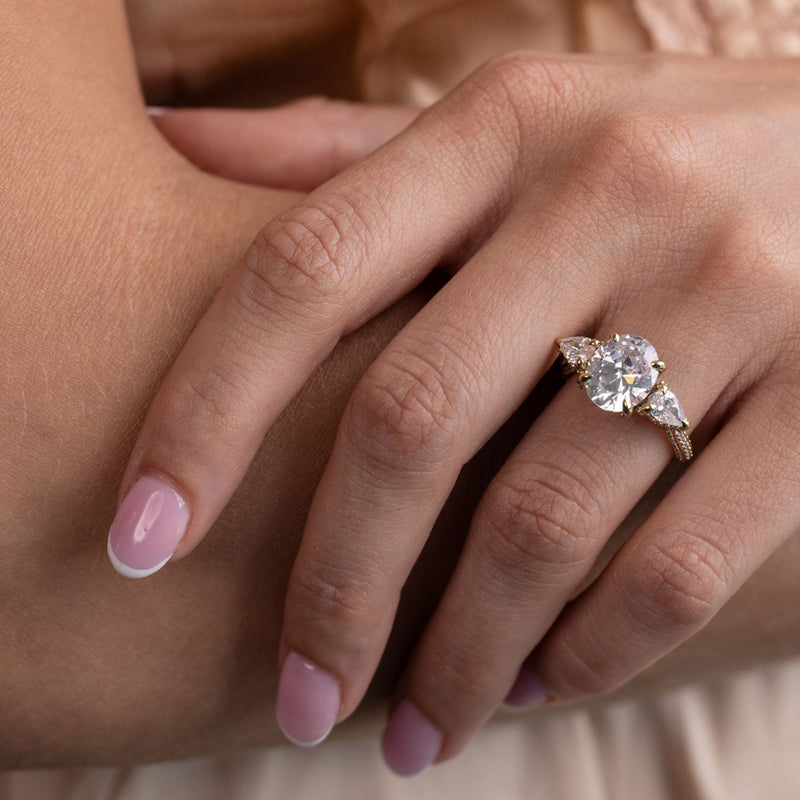 three-stone-oval-diamond-engagement-ring-pear-shaped-diamond-accents-pave-setting-the-marielle-rustic-and-main