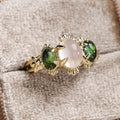 vintage-inspired-three-stone-engagement-ring-oval-moonstone-green-tourmaline-cabochon-stones-the-myzelle-rustic-and-main